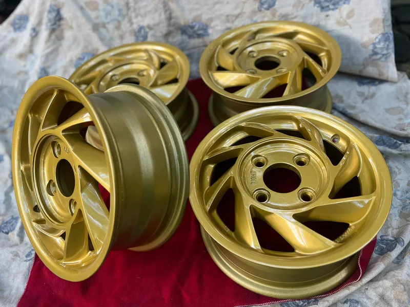 Rare 13-inch Hiseko Aixger directional aero wheels restored in Steel Gold Metallic